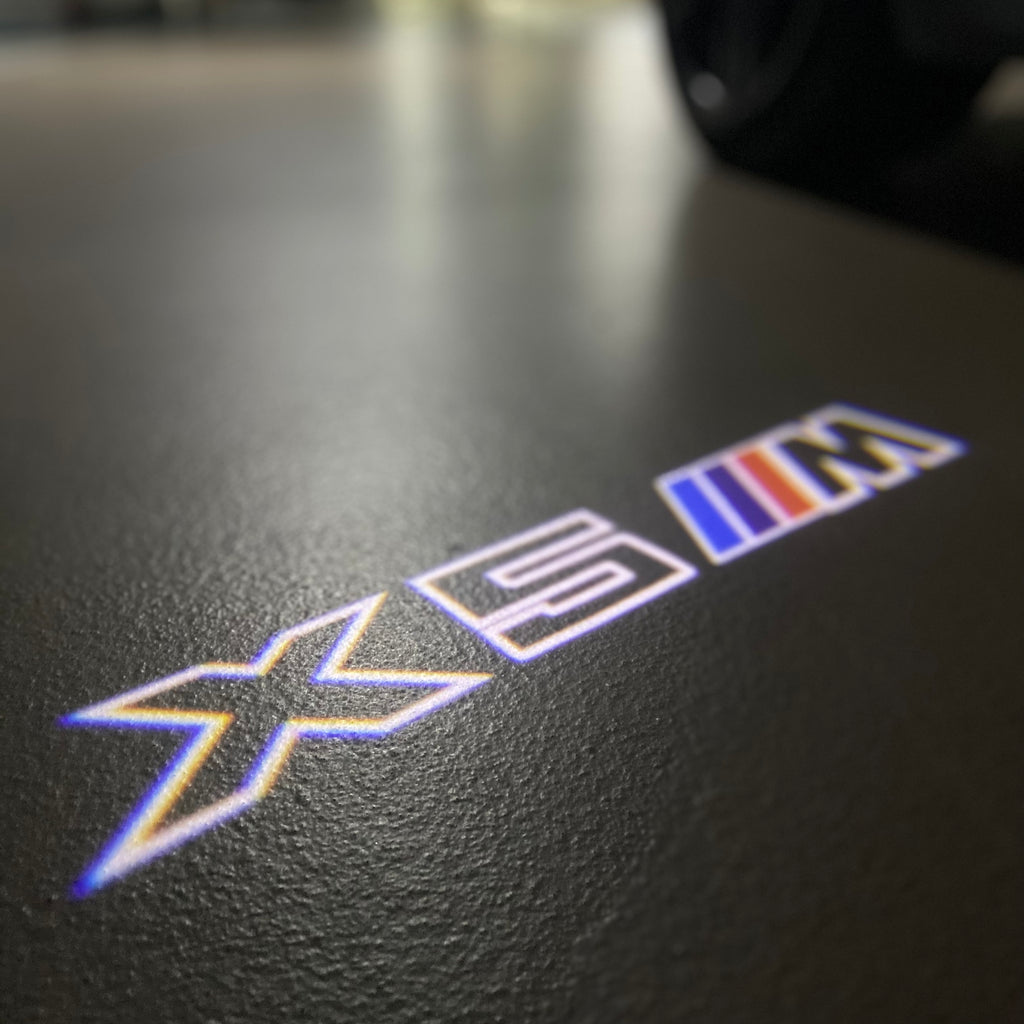BMW X5M LOGO PROJECTOT LIGHTS (quantity 1 = 1 sets/2 door lights) Nr.6024q0t071